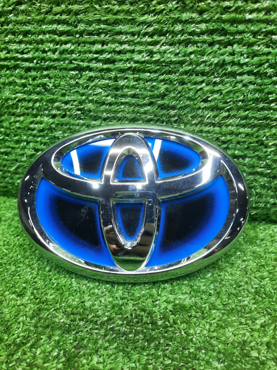 Эмблема TOYOTA AQUA MXPK11 75310-12110 1 ракурс Эмблема TOYOTA AQUA MXPK11 75310-12110 1 ракурс